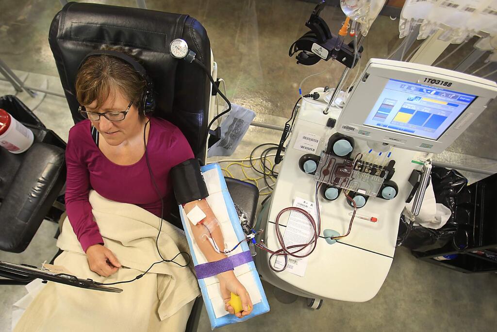 Marcia Belforte of Santa Rosa gives blood that is being separated for platelets at the Blood Centers of the Pacific in Santa Rosa, Monday July 18, 2016. (Kent Porter / Press Democrat) 2016
