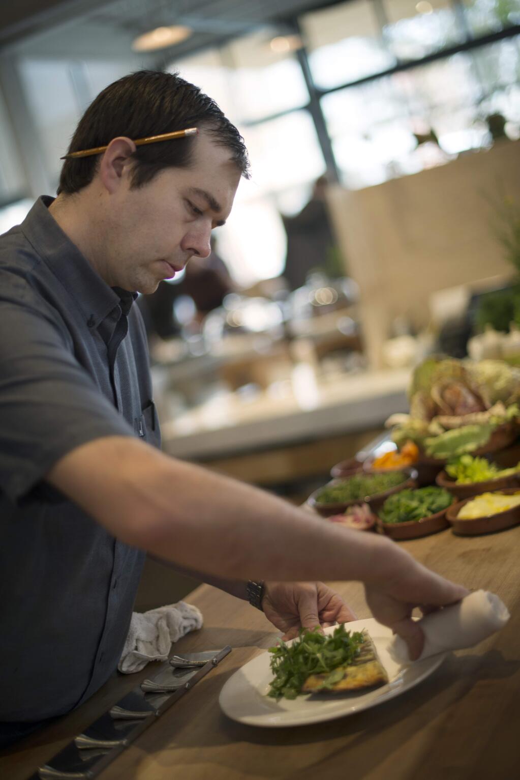 Chef Perry Hoffman making final touches to dishes before they head out to the dining area during a Saturday brunch at SHED in Healdsburg. January 16, 2016. (Photo: Erik Castro/for Sonoma Magazine)