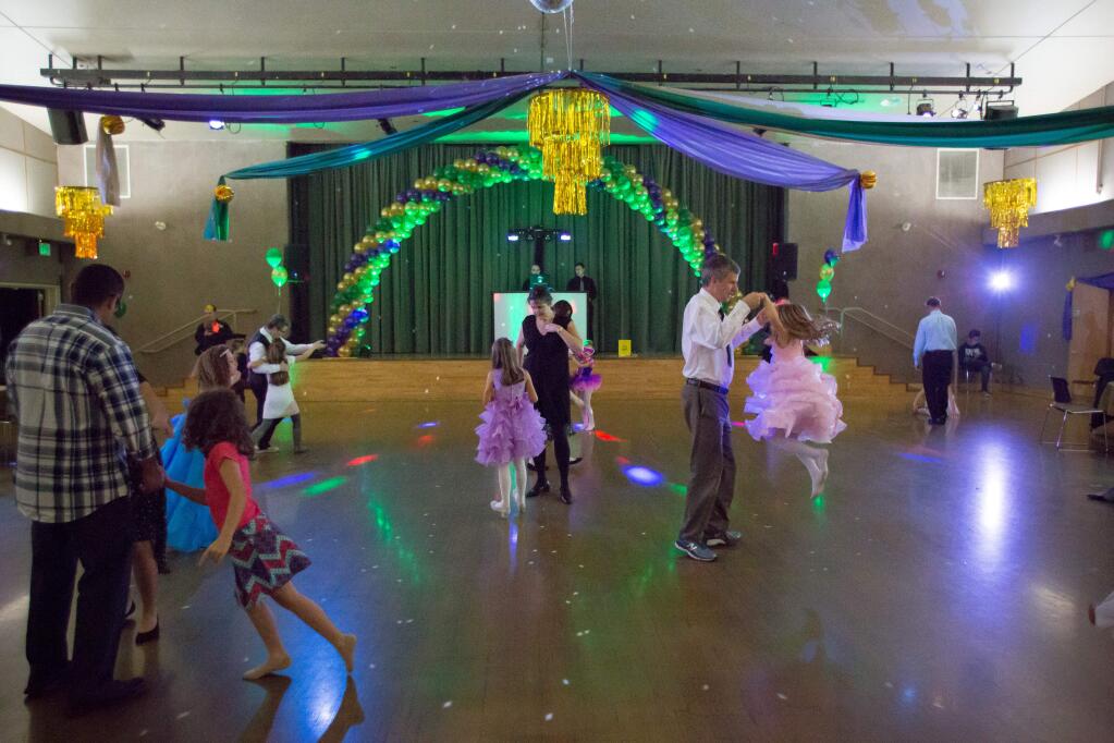 Kids and chaperones boogie the night away during the 2017 Masquerade Ball at the Finley Community Center in Santa Rosa, Calif. Saturday, February 18, 2017. (Jeremy Portje / For The Press Democrat)