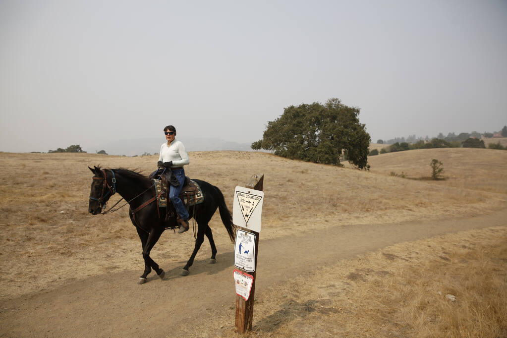 Annette Cooperluiz rides her horse Rocket at Crane Creek Regional Park in Rohnert Park, California, on Sunday, September 13, 2020. (Beth Schlanker/ The Press Democrat)