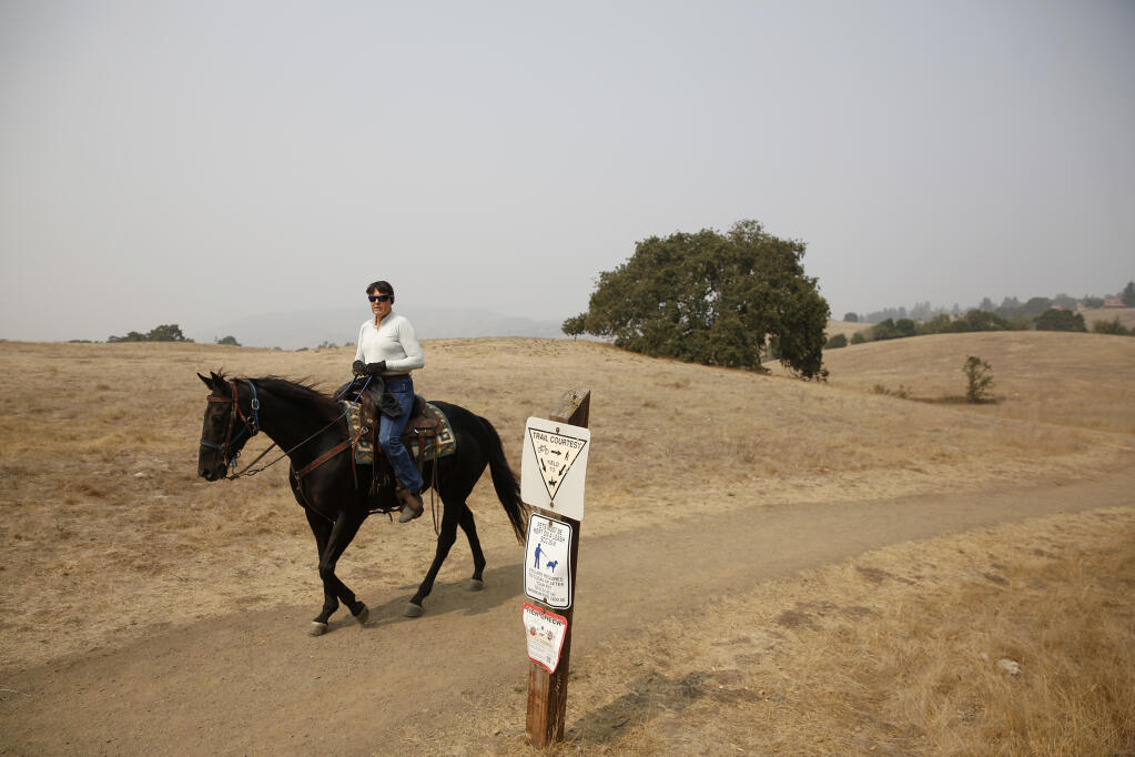 Annette Cooperluiz rides her horse Rocket at Crane Creek Regional Park in Rohnert Park, California, on Sunday, September 13, 2020. (Beth Schlanker/ The Press Democrat)