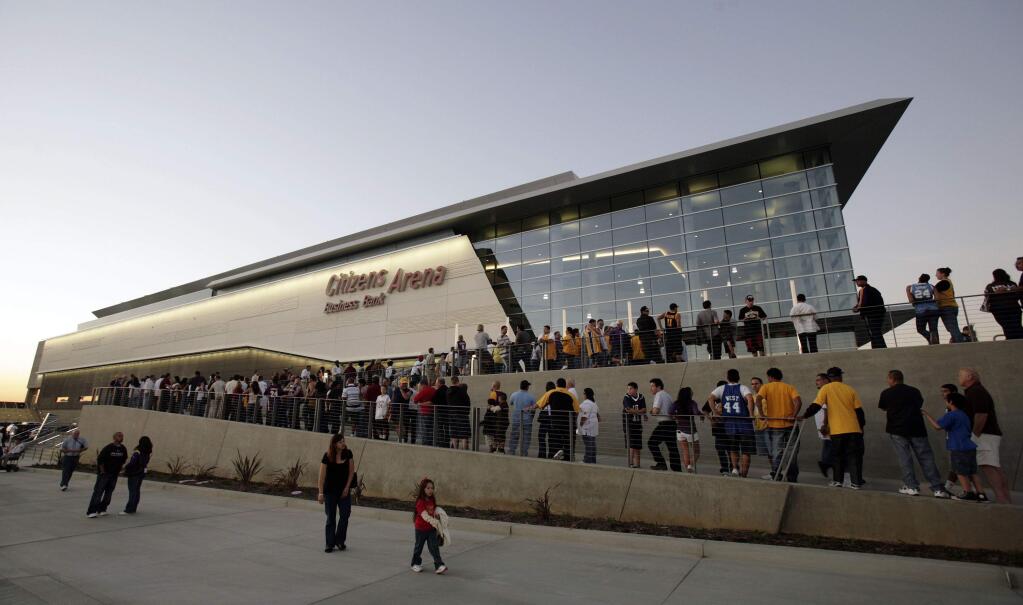 FILE - In this Oct. 24, 2008, file photo, fans line up for the grand opening of the Citizens Business Bank Arena before the Los Angeles Lakers play the Oklahoma City Thunder in an NBA preseason basketball game in Ontario, Calif. The crippling coronavirus pandemic has brought the entire world - including the sports world - to a standstill, and it shows no sign of going away anytime soon. The most obvious change in the short term will be the implementation of social distancing, something that already has permeated everyday life. Ticket sales will be capped and fans will be given an entrance time to prevent crowds at the gate. (AP Photo/Francis Specker, File)