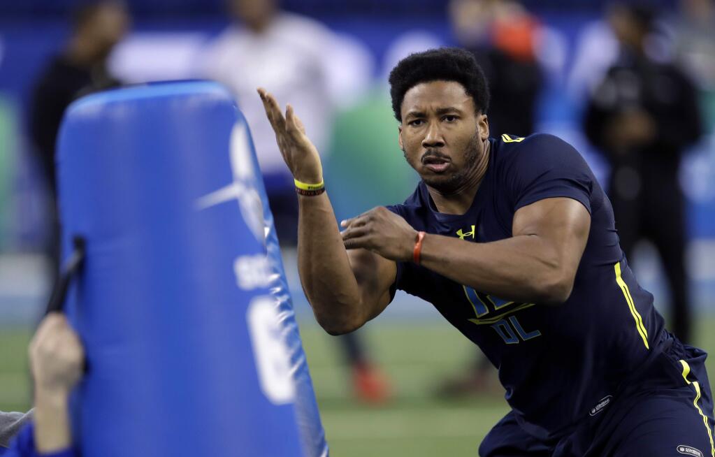 Texas A&M defensive end Myles Garrett hits a blocking dummy during a drill at the NFL scouting combine Sunday, March 5, 2017, in Indianapolis. (AP Photo/David J. Phillip)
