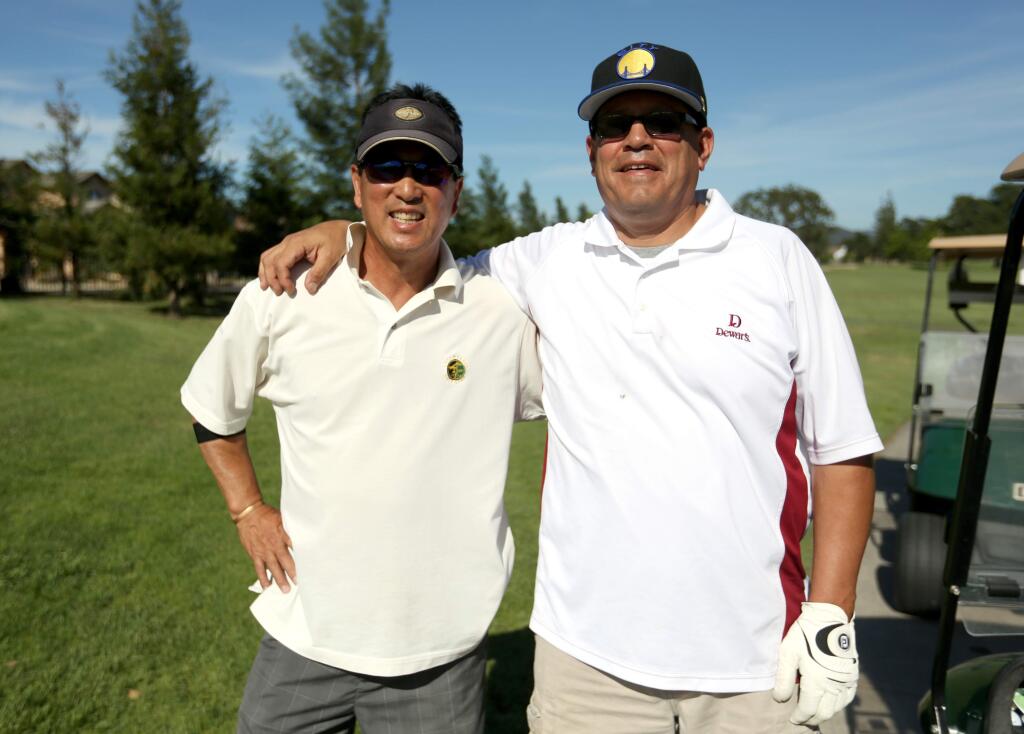 Ron Fong, left and Chris Quintana, right, participated in the Habitat for Humanity of Sonoma County Annual Golf Tournament at the Windsor Golf Course, Friday, June 19, 2015. (CRISTA JEREMIASON / The Press Democrat)