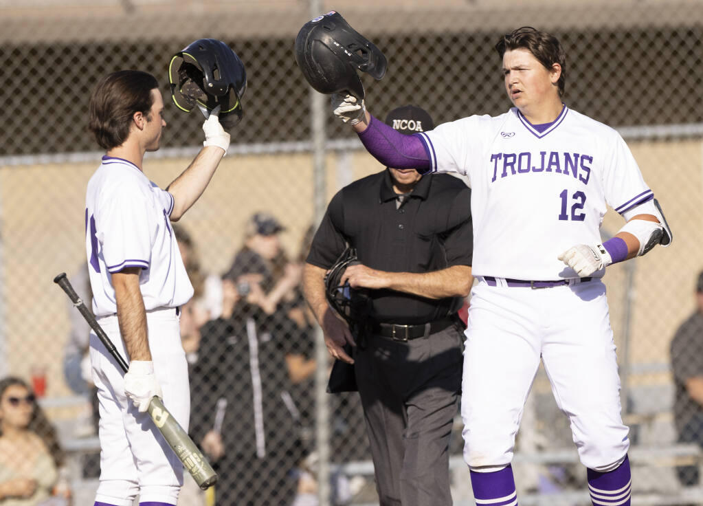 Petaluma first baseman Aaron Davainis is greeted at home plate by a teammate after his 4th inning home run against Windsor on Wednesday, March 16, 2022. (John Burgess/The Press Democrat)