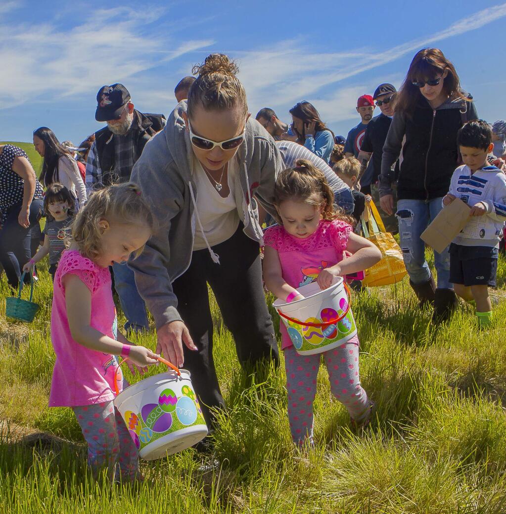 Makayla and Makenzie look at the eggs they found in the field at Adobe Christian Church in Petaluma on Saturday, March 26, 2016. This year's Adobe Christian Easter Eggstravaganza will be held April 20, 2019. (JOHN O'HARA / FOR THE ARGUS-COURIER)