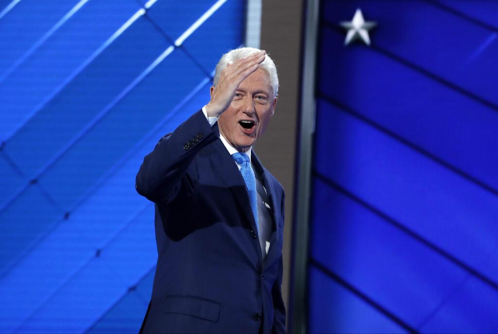 Former President Bill Clinton salutes after speaking to the delegates during the second day session of the Democratic National Convention in Philadelphia, Tuesday, July 26, 2016. (AP Photo/Carolyn Kaster)