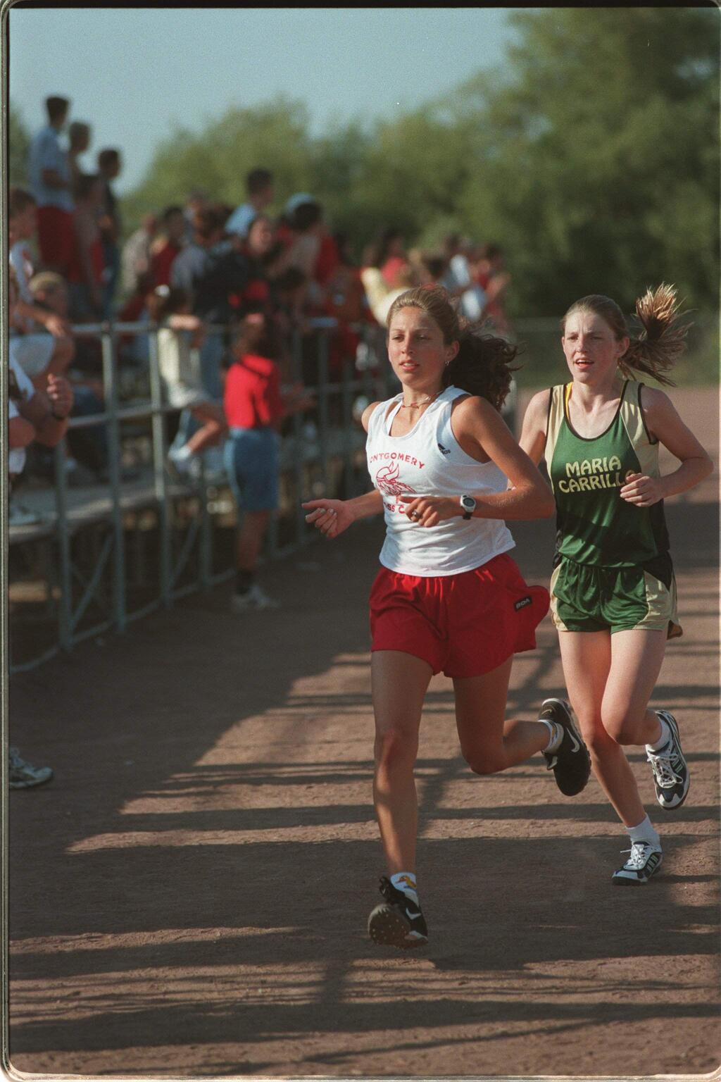 Montgomery's Sara Bei leads Maria Carrillo's Jenny Aldridge out of the stadium at Rancho Cotate High at the start of the cross country race; they finished in the same order. (JEFF KAN LEE/ PD)
