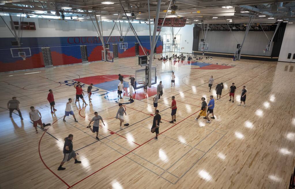 Students stretch before gym class in the new $52 million, 75,000 square foot TAG (Theater, Arts, Gym) building on the Rancho Cotati High School Campus in Rohnert Park. (photo by John Burgess/The Press Democrat)
