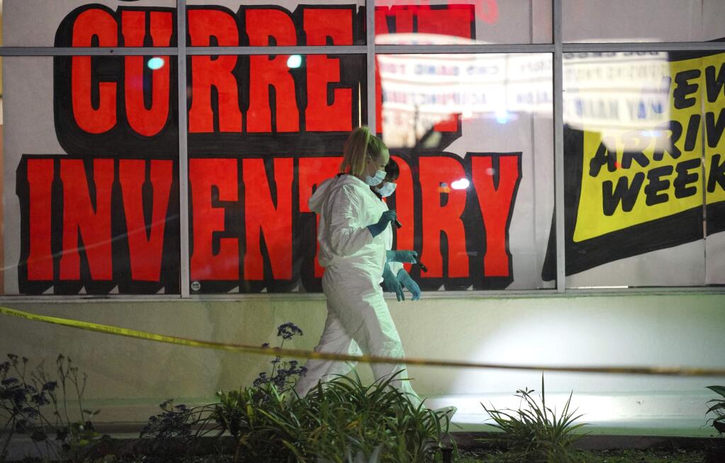 Investigators look for evidence around a shopping center adjacent to the Gable House Bowl following a shooting in Torrance, Calif., on Saturday, Jan. 5, 2019. Police responded shortly after midnight to calls of shots fired at the bowling ally. Several people were injured. (Scott Varley/The Orange County Register via AP)