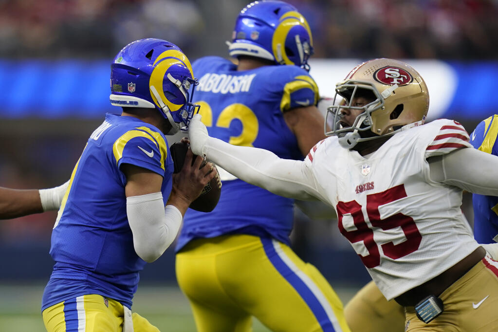 San Francisco 49ers defensive end Drake Jackson, right, attempts to sack Los Angeles Rams quarterback Matthew Stafford during the second half of an NFL football game Sunday, Oct. 30, 2022, in Inglewood, Calif. (AP Photo/Gregory Bull)