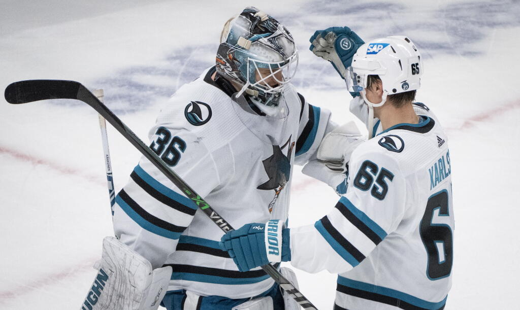 The Sharks’ Erik Karlsson congratulates goaltender Kaapo Kahkonen after shutting out the Canadiens Tuesday in Montreal. (Paul Chiasson / Canadian Press)