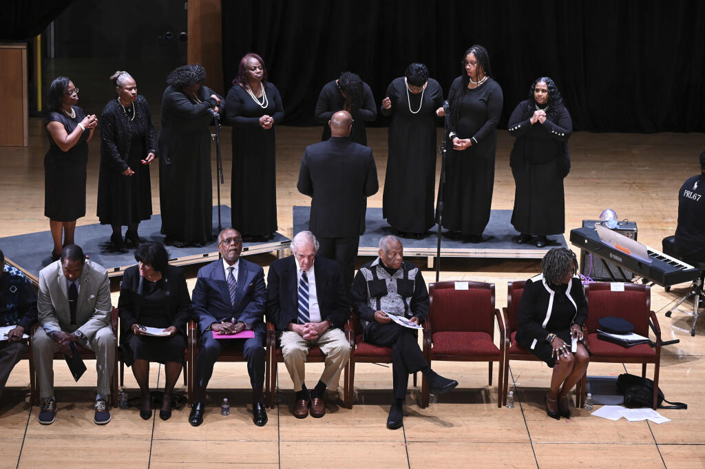 Attendees react moments after JoAnne A. Epps, acting president of Temple University, is carried out after collapsing on stage during a public memorial service for Charles L. Blockson at the Temple University Performing Arts Center in Philadelphia, Tuesday, Sept. 19, 2023. (Tom Gralish/The Philadelphia Inquirer via AP)