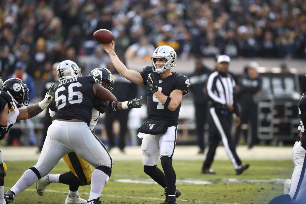Oakland Raiders quarterback Derek Carr (4) passes against the Pittsburgh Steelers during the second half of an NFL football game in Oakland, Calif., Sunday, Dec. 9, 2018. (AP Photo/Ben Margot)