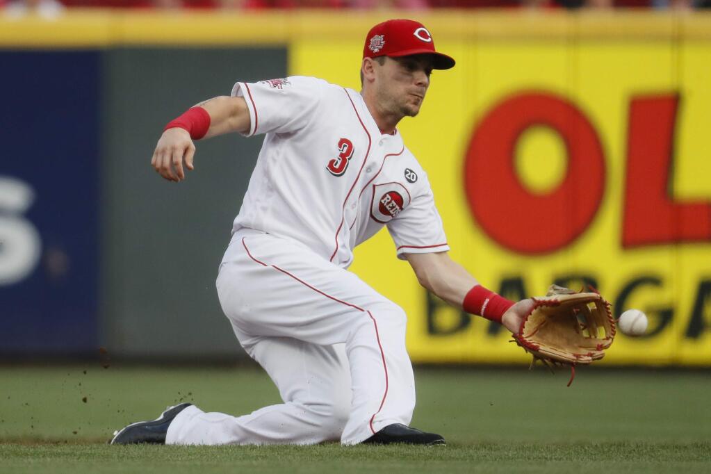 Cincinnati Reds second baseman Scooter Gennett fields the ball before tagging out the Pittsburgh Pirates' Adam Frazier on a steal attempt, Monday, July 29, 2019, in Cincinnati Gennett was traded to the Giants this week. (AP Photo/John Minchillo)