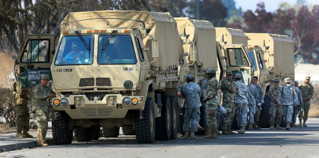 This Oct. 16, 2017, photo shows the California National Guard deployed near Santa Rosa, Calif. President Donald Trump slammed California Gov. Jerry Brown's posture on sending National Guard troops to the Mexican border Tuesday, April 17, 2018, even as Brown said he was nearing agreement on joining the president's mission and that his troops were 'chomping at the bit ready to go.' (Kent Porter/The Press Democrat via AP)