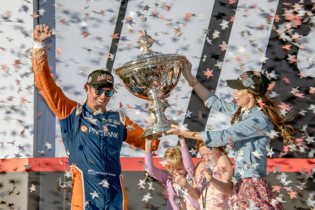 Scott Dixon raises a fist in triumph after taking his fifth IndyCar series championship on Sept. 16, 2018, at Sonoma Raceway. He shares the moment with his wife Emma and children, Poppy and Tilly. (Mike Finnegan/Sonoma Raceway)
