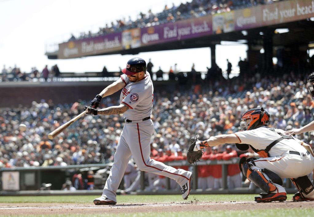 Washington Nationals' Matt Adams hits a single during the first inning of a baseball game against the San Francisco Giants Wednesday, April 25, 2018, in San Francisco. (AP Photo/Marcio Jose Sanchez)