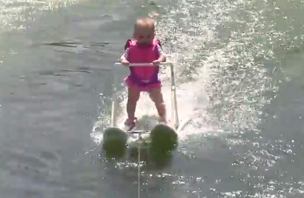 In this photo taken from a video made available by World Barefoot Center, 6-month-old Zyla St. Onge water-skis across Lake Silver in Winter Haven, Fla., Thursday, May 19, 2016. Her parents who are professional water skiers, put her on junior-size water skis and she glided 686 feet across the lake. Her father Keith St. Onge says she set a youth record. (World Barefoot Center via AP)