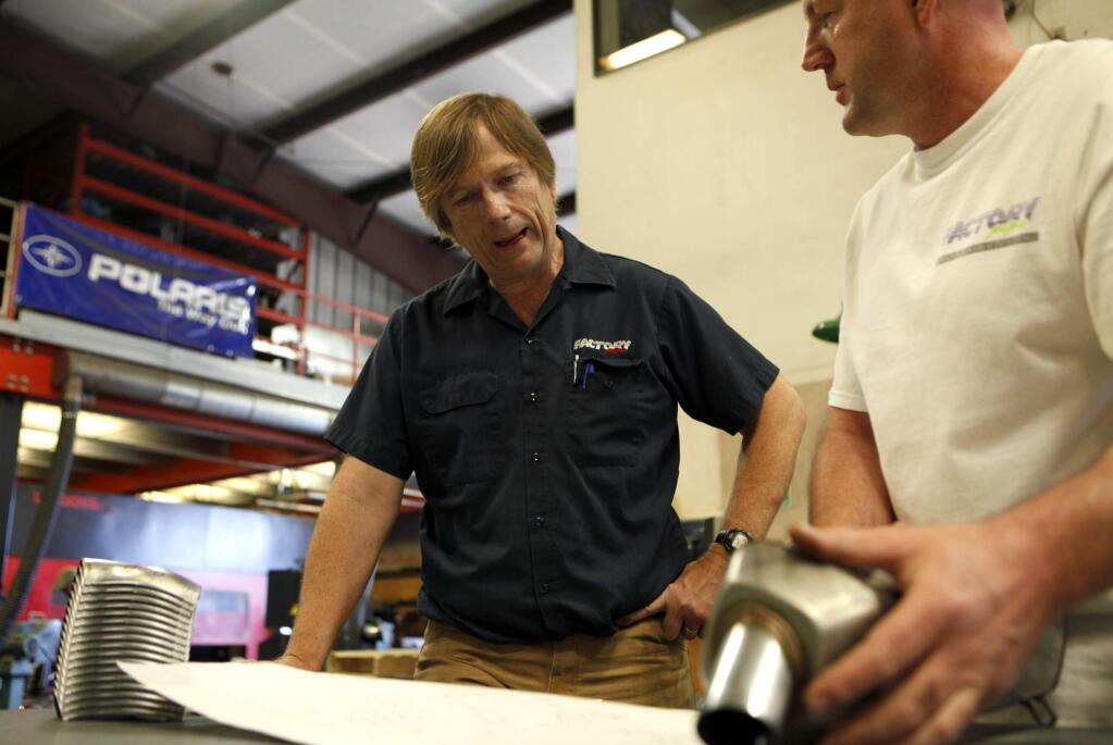 Factory Pipe owner Ross Liberty, left, talks with quality control manager Wayne Otton about the development of a new muffler for Polaris on Monday, July 9, 2012, in Ukiah (BETH SCHLANKER/ The Press Democrat)