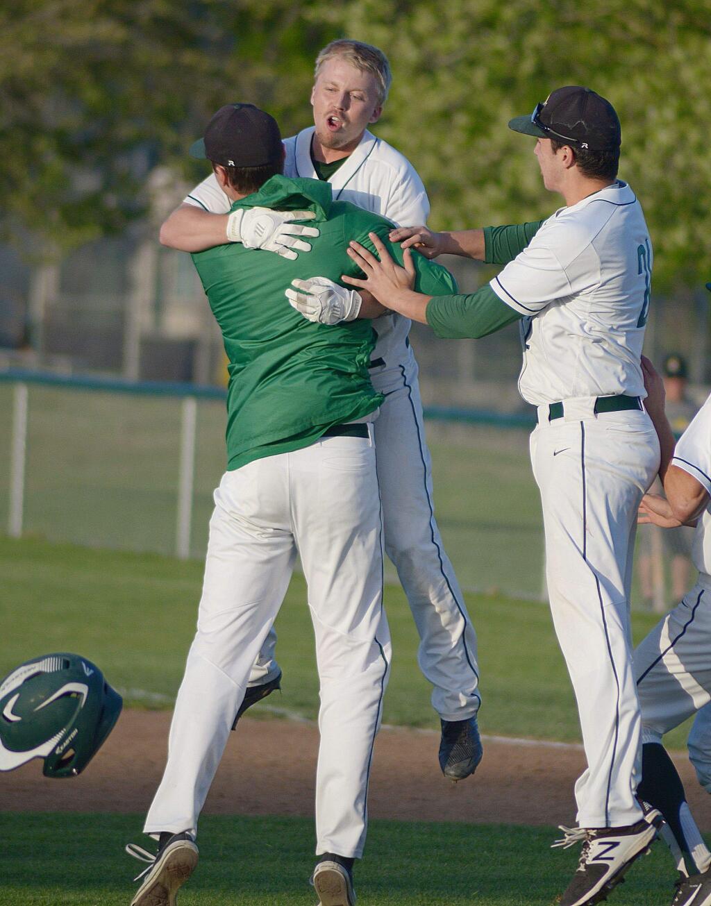 SUMNER FOWLER/FOR THE ARGUS-COURIERDylan Moore gets a hug for the hero after his 12th-inning single ended a marathon game with a 6-5 win for Casa Grande.