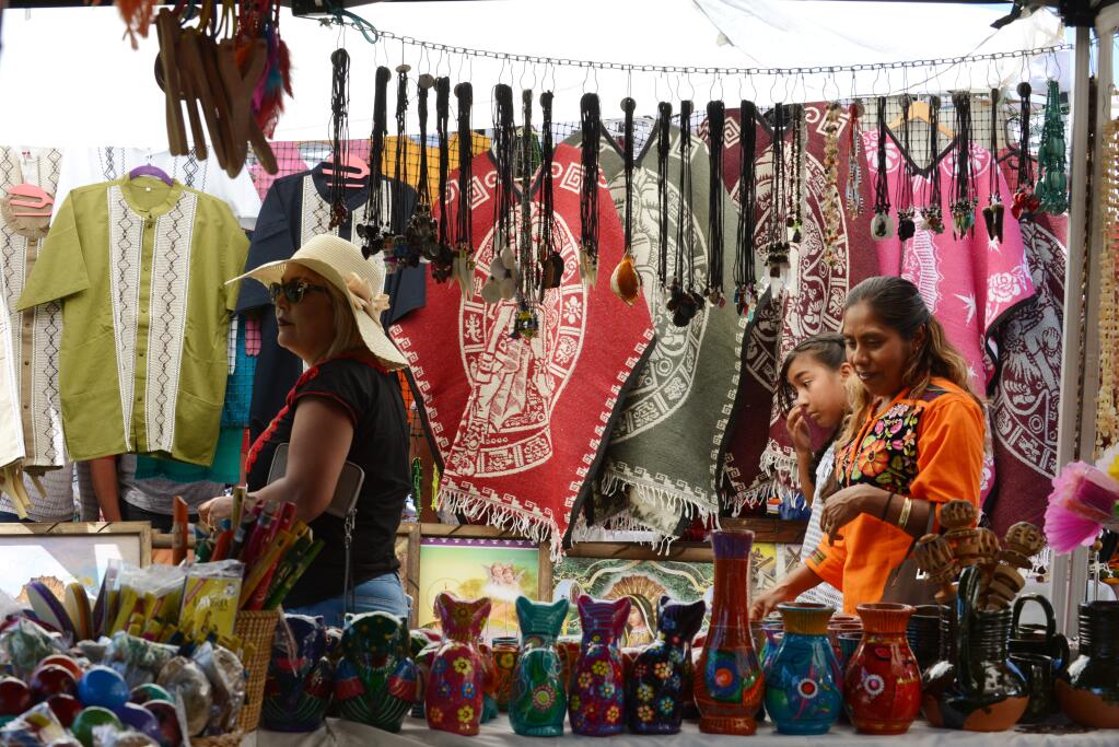 Festival attendees looking over Oaxacan made items for sale during the 6th Guelaguetza Sonoma County 2017; a festival celebrating the diverse traditions from the state of Oaxaca, Mexico. The event was organized by Oaxaca Tierra del Sol and held Sunday at the Luther Burbank Center for the Arts in Santa Rosa, California. July 16 2017.(Photo: Erik Castro/for The Press Democrat)