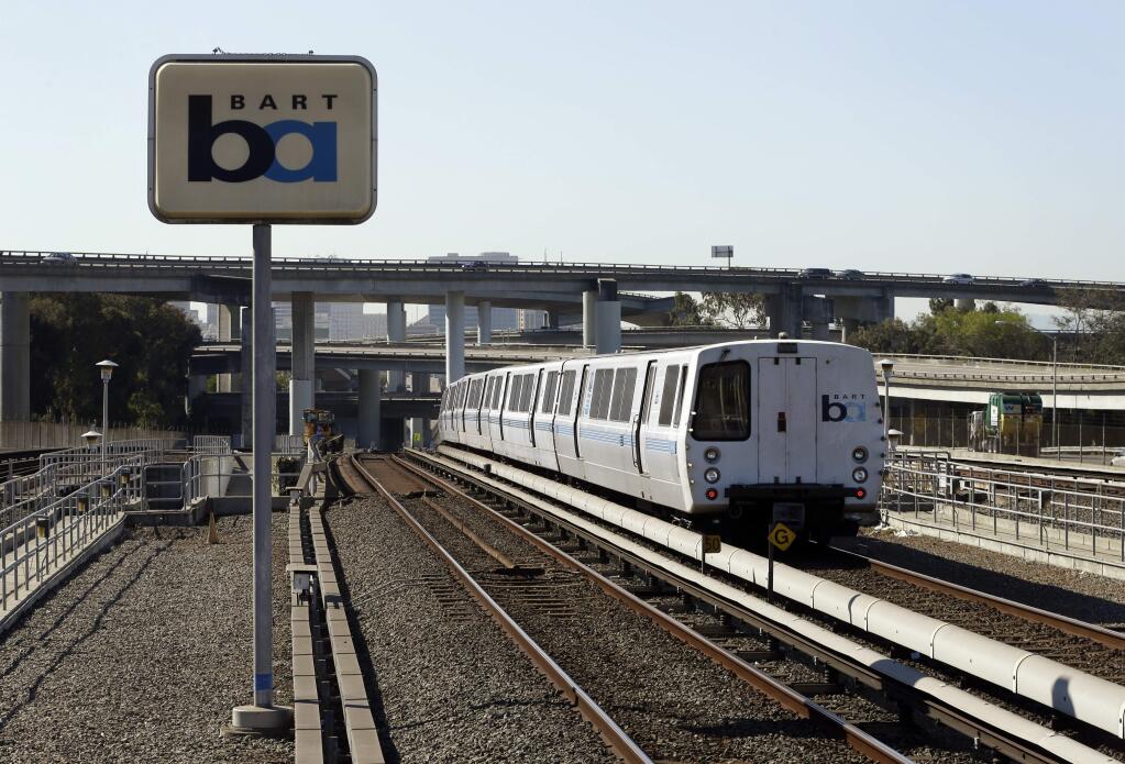 FILE - In this Oct. 15, 2013 file photo, a Bay Area Rapid Transit train leaves the station in Oakland, Calif. Regulators fined a Northern California transit agency $650,000 for safety failures that led to a train fatally striking two workers inspecting track five years ago during a union strike. (AP Photo/Ben Margot, File)