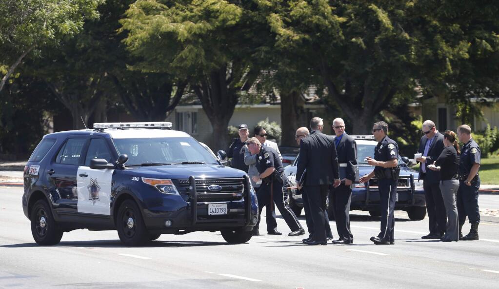 San Jose police investigate the scene of an officer involved shooting in the 700 block of Blossom Hill Road Thursday, Aug. 14, 2014, in San Jose. There were reports that a San Jose police officer or officers shot a woman who was reported to be threatening to shoot members of her family in south San Jose near the Oakridge Mall. (AP Photo/Bay Area News Group, Patrick Tehan)