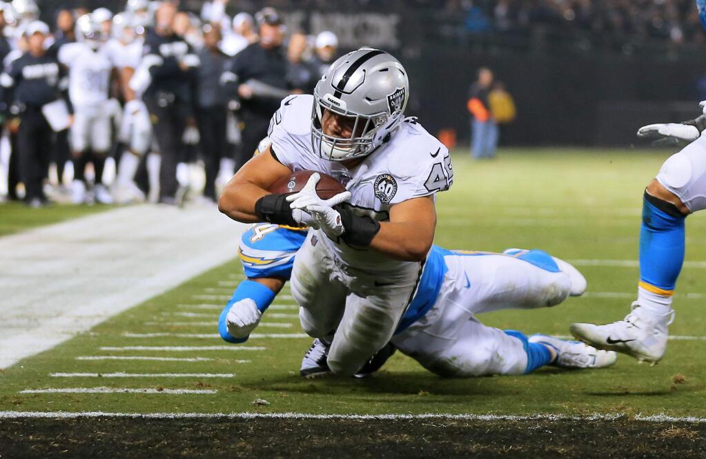 Oakland Raiders running back Alec Ingold dives into the end zone for a touchdown near the end of the second quarter against the Los Angeles Chargers in Oakland on Thursday, November 7, 2019. (Christopher Chung/ The Press Democrat)