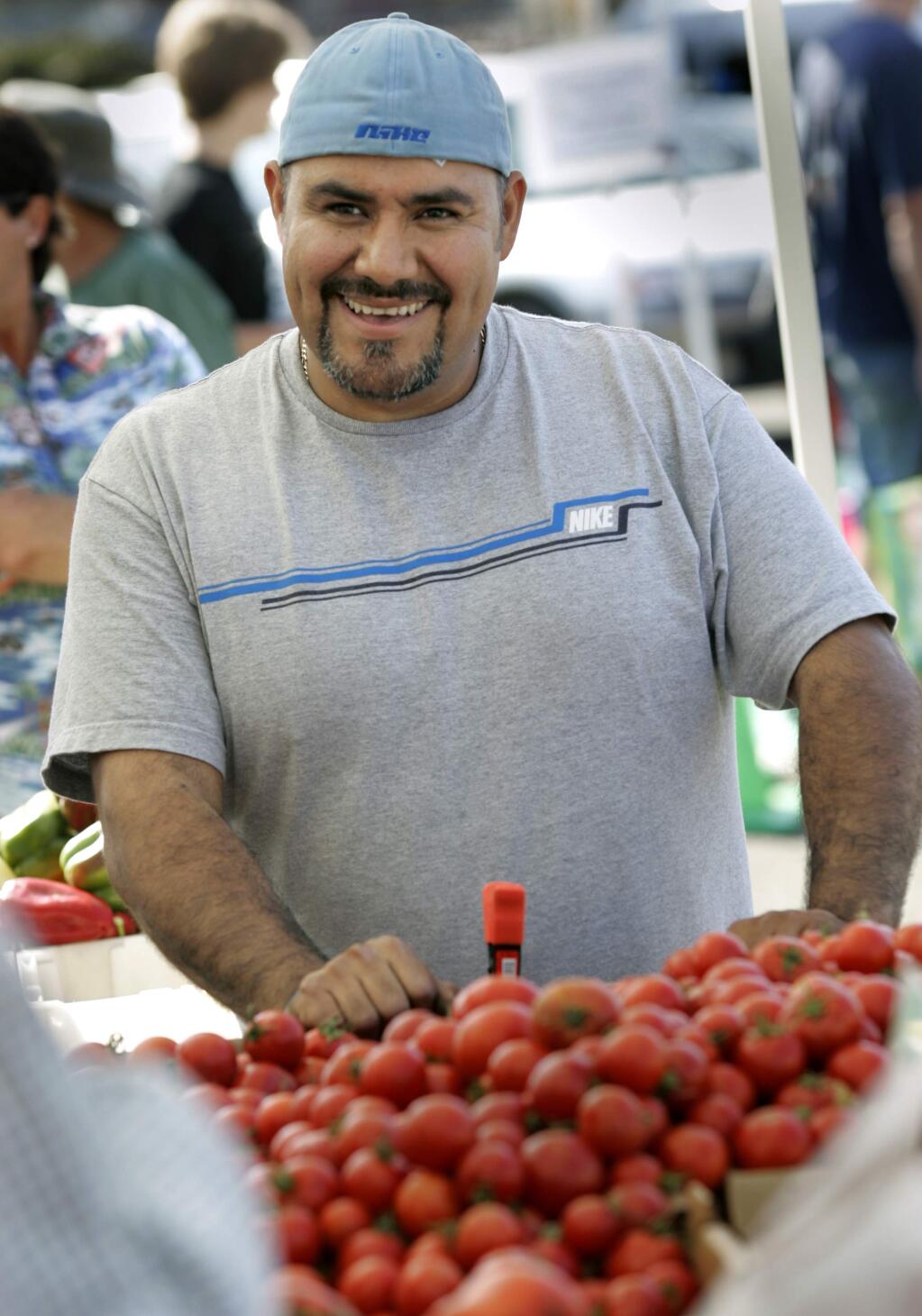 Lazaro Calderon of 'The Patch' in Sonoma sells his fruits and vegetables at the Santa Rosa farmers market, Saturday September 26, 2009. (Kent Porter / Press Democrat)