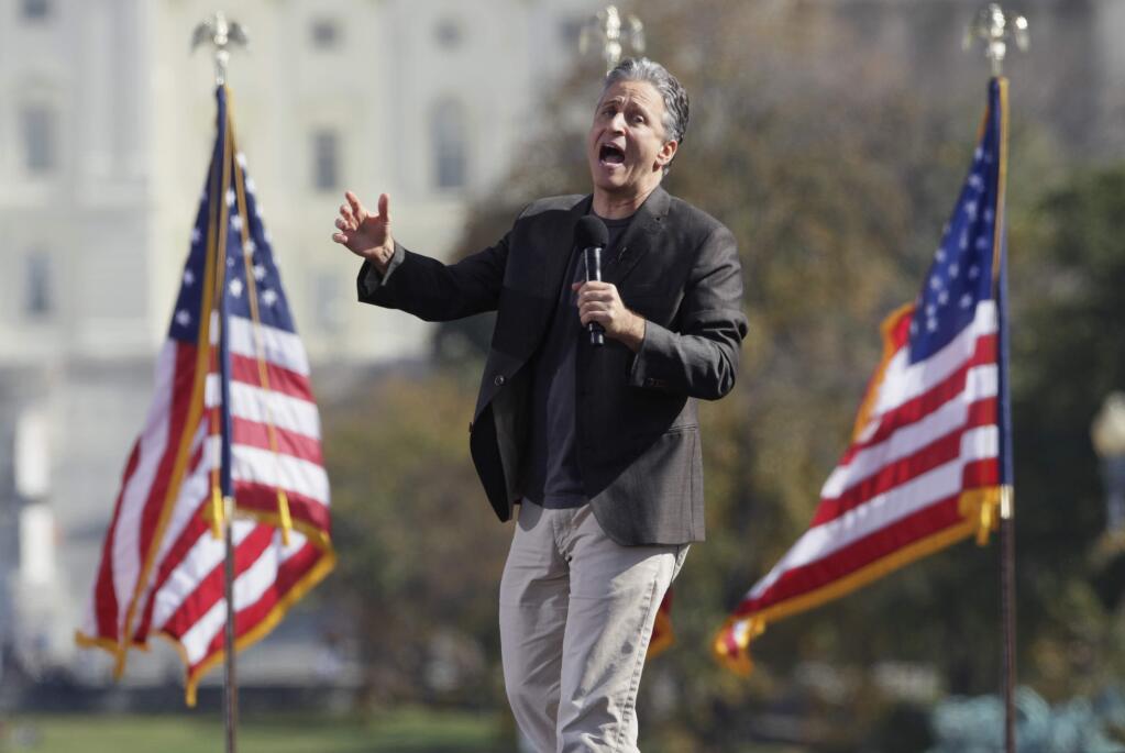 FILE - In a Oct. 30, 2010 file photo, comedian Jon Stewart shouts to the crowd during the Rally to Restore Sanity and/or Fear on the National Mall in Washington. After hosting nearly 2600 editions of 'The Daily Show with Jon Stewart,' Stewart will sign off for good on Aug. 6. (AP Photo/Carolyn Kaster, File)