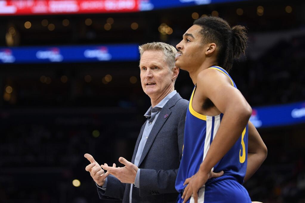 Golden State Warriors head coach Steve Kerr, left, talks with guard Jordan Poole, right, during the first half against the Washington Wizards, Monday, Feb. 3, 2020, in Washington. (AP Photo/Nick Wass)