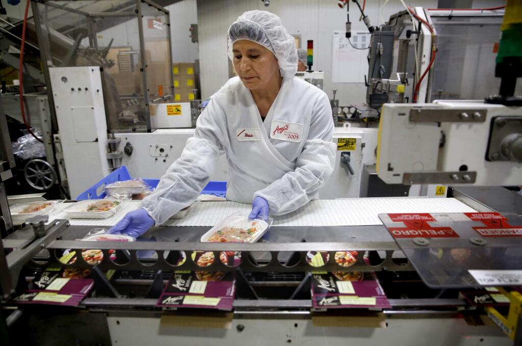 Amy's Kitchen employee Maria Rosa Vazquez boxes frozen meals at the production plant on Wednesday, March 11, 2015. The company is recalling 74,000 cases of multiple food products because the spinach in the frozen dishes may contain the harmful bacterium Listeria monocytogenes. (BETH SCHLANKER/ PD)