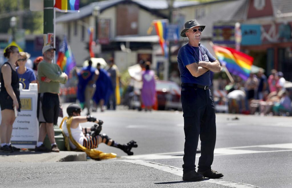 Monte Rio Fire Chief Steve Baxman takes a moment from directing traffic to watch the Sonoma County Gay Pride Parade in Guerneville, on Sunday, June 5, 2016. (BETH SCHLANKER/ The Press Democrat)
