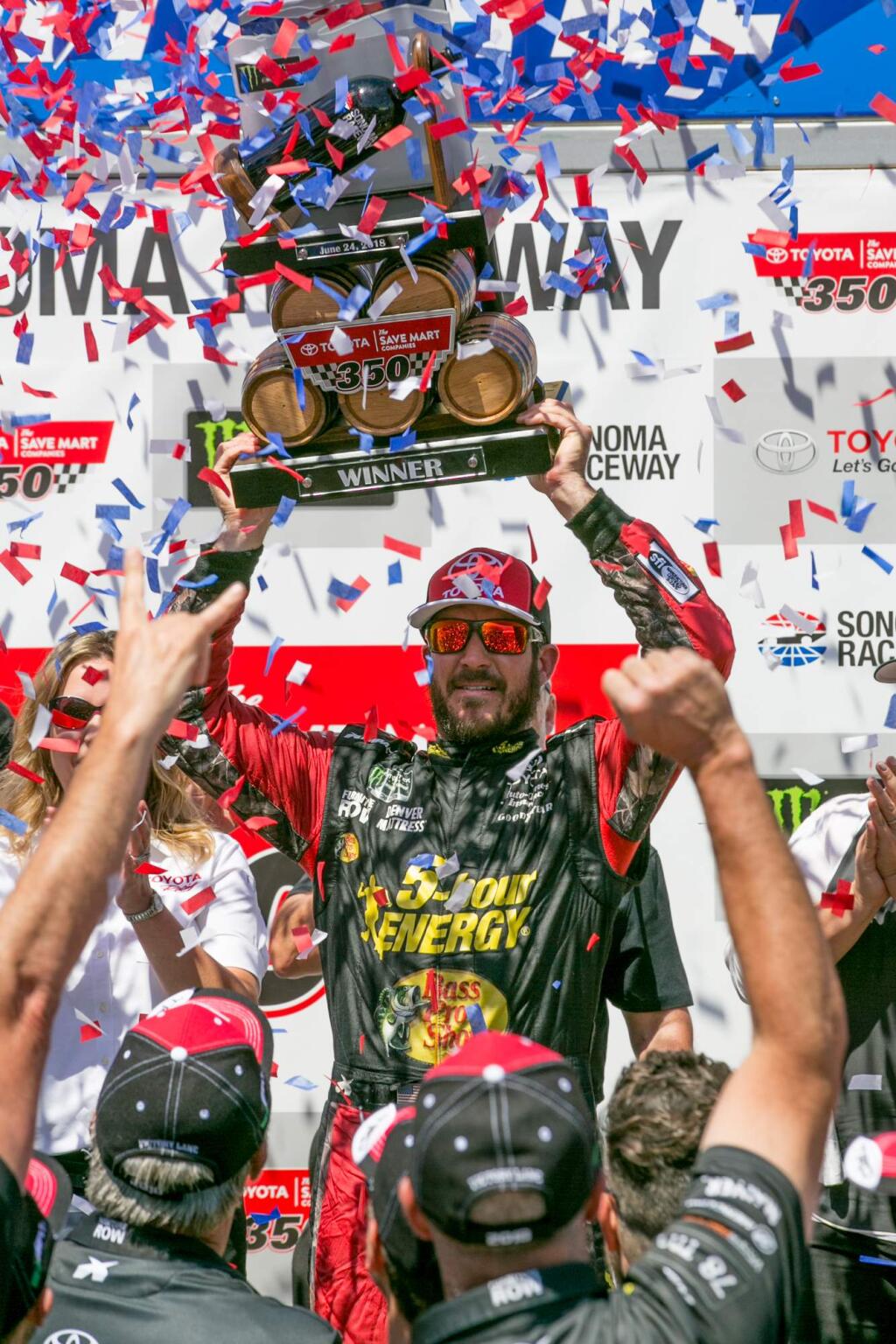Martin Truex, Jr. hoists the elaborate--and heavy--trophy for winning at Sonoma Raceway's Toyota/Save Mart 350 Sunday, June 24, 2018. (Photo by Julie Vader/special to the Index-Tribune)