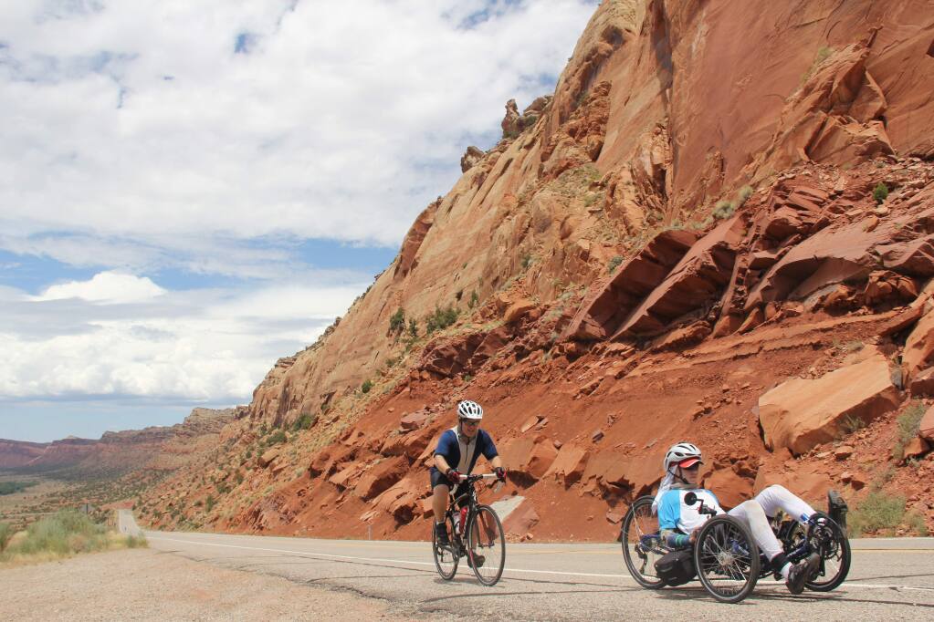 Tucker Cullen, 15, followed by his father Shawn Cullen, cycle outside of Capitol Reef, Utah during Tucker's marathon ride across the United States. (Photo by Anne Cullen)