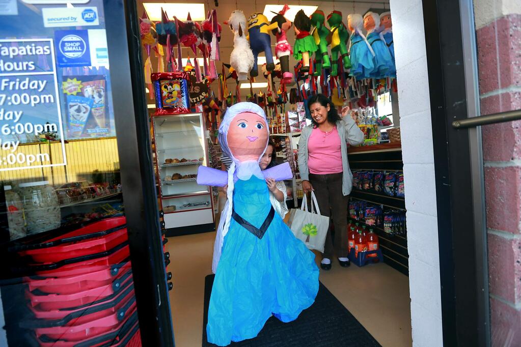 Monserrat Vargas, 7, chose Elsa from 'Frozen' for her birthday pinata at the Dulceria Las Tapatias in Santa Rosa. (Photo by John Burgess/The Press Democrat)
