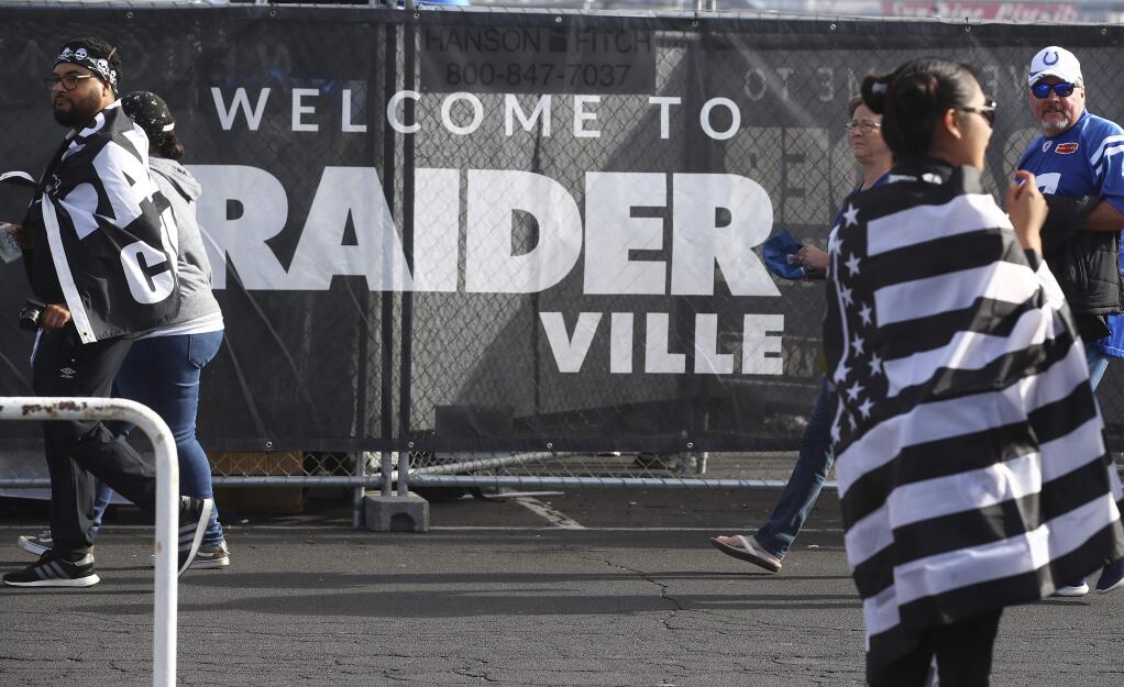 Fans tailgate at Oakland Alameda County Coliseum before a game between the Oakland Raiders and the Indianapolis Colts on Sunday, Oct. 28, 2018. (AP Photo/Ben Margot)