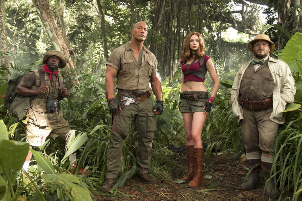 From left, Kevin Hart, Dwayne Johnson, Jack Black and Karen Gillan play teenagers who have been transfoirmed and unwitting players in an old video game in 'Jumanji.' (Columbia Pictures)