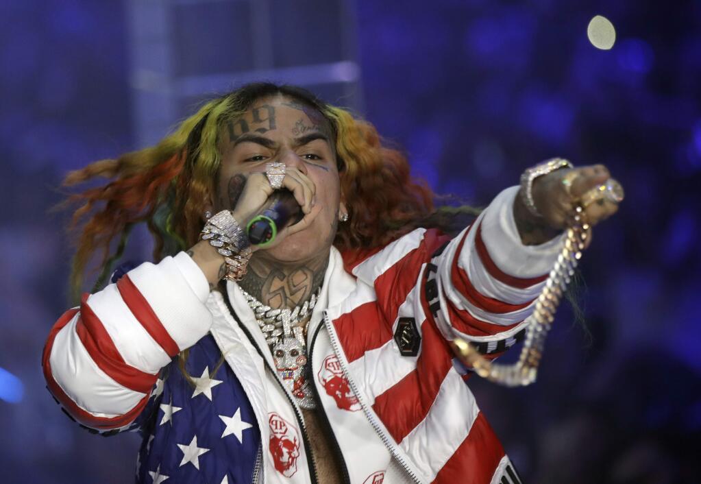 FILE- In this Sept. 21, 2018, file photo rapper Daniel Hernandez, known as Tekashi 6ix9ine, performs during the Philipp Plein women's 2019 Spring-Summer collection, unveiled during the Fashion Week in Milan, Italy. Tekashi 6ix9ine was sentenced to 2 years in prison Wednesday, Dec. 18, 2019 for his entanglement with a violent street gang that fueled his rise to fame, but was spared a much harsher possible sentence because of his extraordinary decision to become a star witness for prosecutors. (AP Photo/Luca Bruno, File)