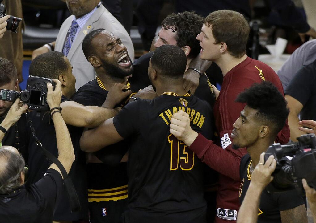 Cleveland Cavaliers forward LeBron James, top left, celebrates with teammates after Game 7 of basketball's NBA Finals against the Golden State Warriors in Oakland, Sunday, June 19, 2016. The Cavaliers won 93-89. (AP Photo/Eric Risberg)