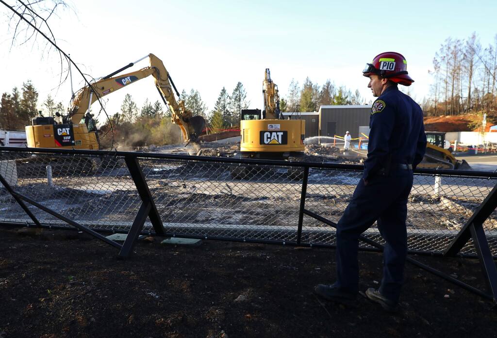 (File photo) Santa Rosa Assistant Fire Marshal Paul Lowenthal watches excavators remove debris from the burned down Santa Rosa Fire Station 5 on Newgate Court, off of Fountaingrove Parkway in Santa Rosa on Thursday, December 14, 2017. (Christopher Chung/ The Press Democrat)