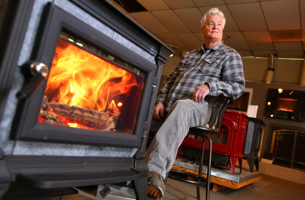 Eric Miller, owner of Warming Trends, sells compliant wood-burning fireplaces and stoves alongside gas fireplaces at his Santa Rosa store.(Christopher Chung/ The Press Democrat)