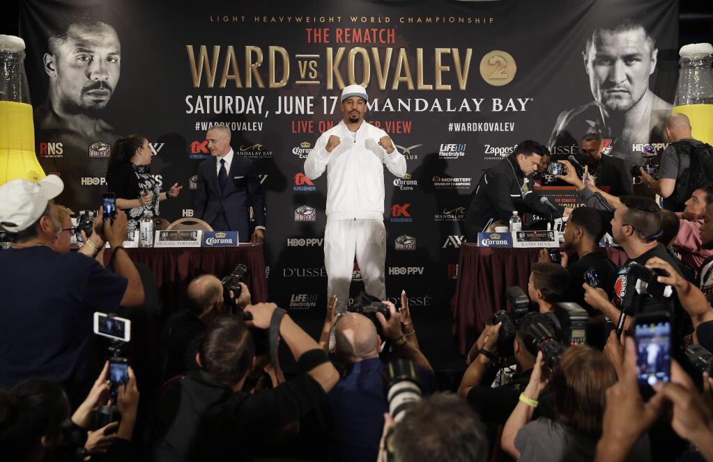 Andre Ward, center, poses for photographers during a news conference Thursday, June 15, 2017, in Las Vegas. Ward is scheduled to fight Sergey Kovalev in a light heavyweight championship boxing match Saturday in Las Vegas. (AP Photo/John Locher)