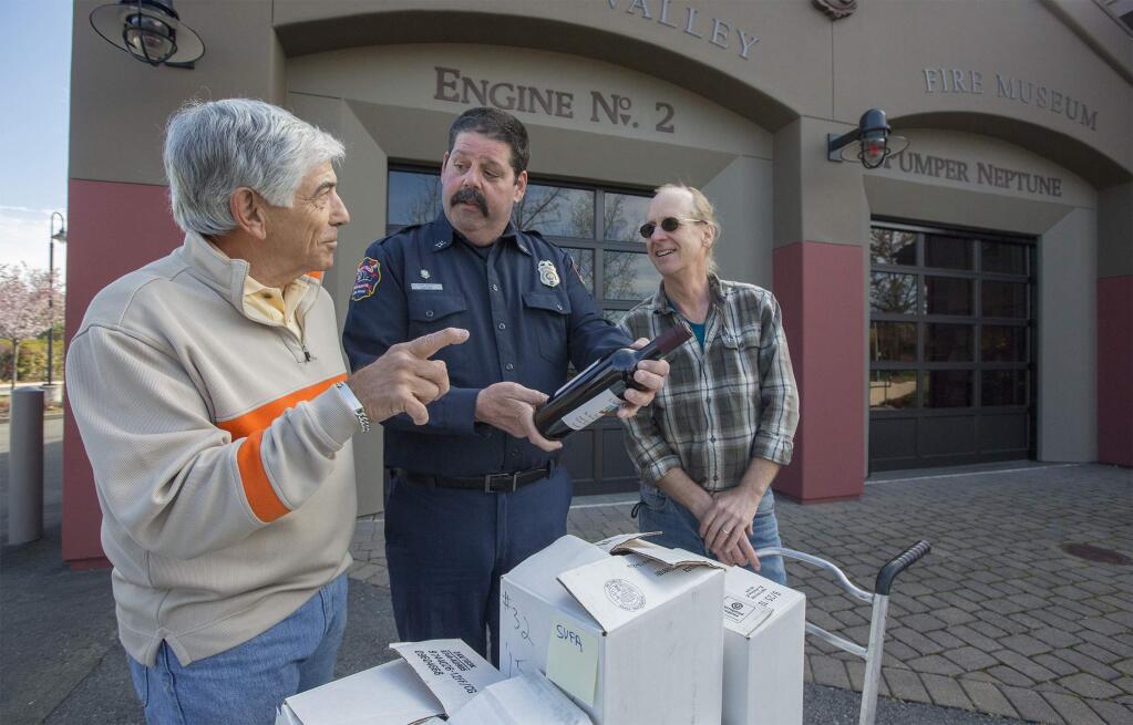 Photos by Robbi Pengelly/Index-TribuneSonoma Valley Fire Department Capt.Tom Deely (center) chats with members of Sonoma Home Winemakers John Randazzo (left) and J.W. Nickel. The home winemakers group donated approximately 237 bottles of their locally made wine to the five Sonoma Valley firehouses on Wednesday, Mar. 7, to thank them for their efforts during the recent firestorm. (Photo by Robbi Pengelly/Index-Tribune)