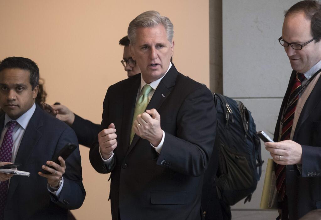 Majority Leader Kevin McCarthy, R-Calif., walks with reporters as work continues on preventing a weekend federal shutdown, at the Capitol in Washington, Wednesday, Jan. 17, 2018. (AP Photo/J. Scott Applewhite)