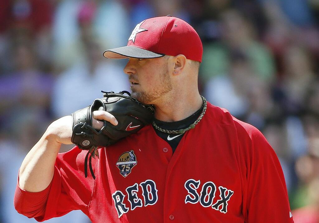 Boston Red Sox's Jon Lester pitches in the fifthinning of the first game of a baseball doubleheader against the Baltimore Orioles in Boston, Saturday, July 5, 2014. (AP Photo/Michael Dwyer)