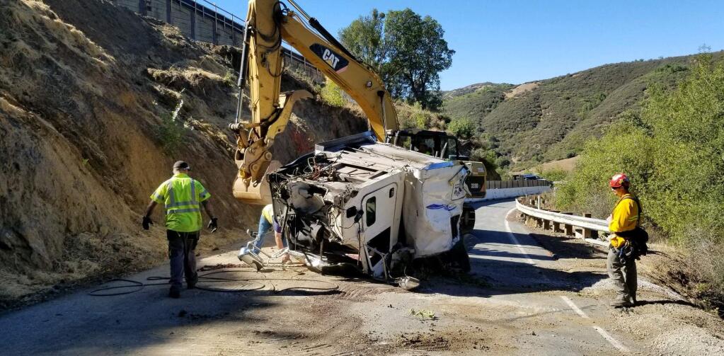 Crews remove a wrecked big rig and its load of plywood from Highway 175 near Hopland on Monday, Oct. 15, 2018. The big rig crashed off the highway on Friday, Oct. 12, 2018. (HOPLAND FIRE BATTALION CHIEF RON ROYSOM)
