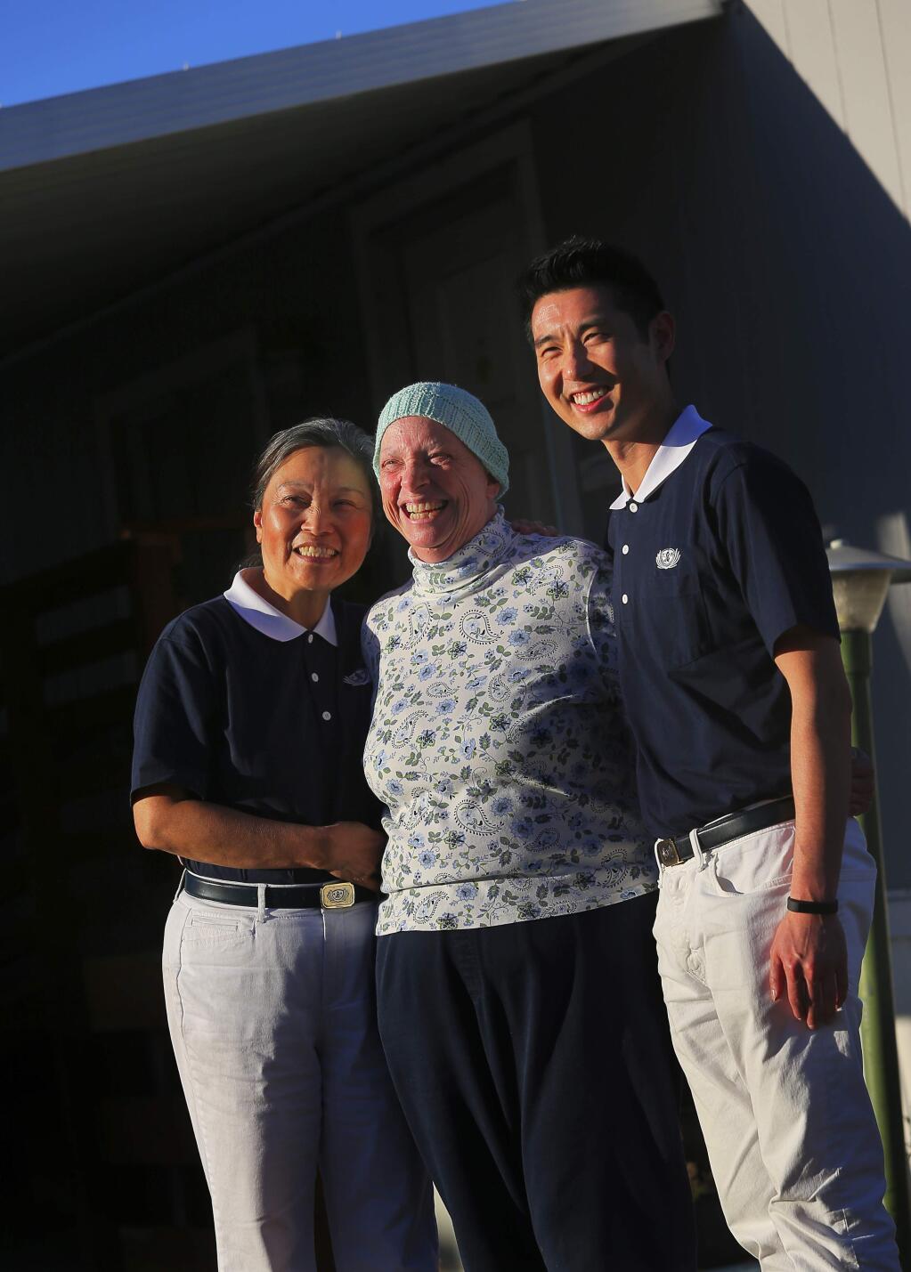 Jenny Yao, left, and Howard Tong, right, both with the Tzu Chi Foundation, have helped Christine Montgomery, and other Journey's End residents, with the foundation providing money for those in need of help with housing, health, and other expenses, as well as advocating for their needs.(Christopher Chung/ The Press Democrat)