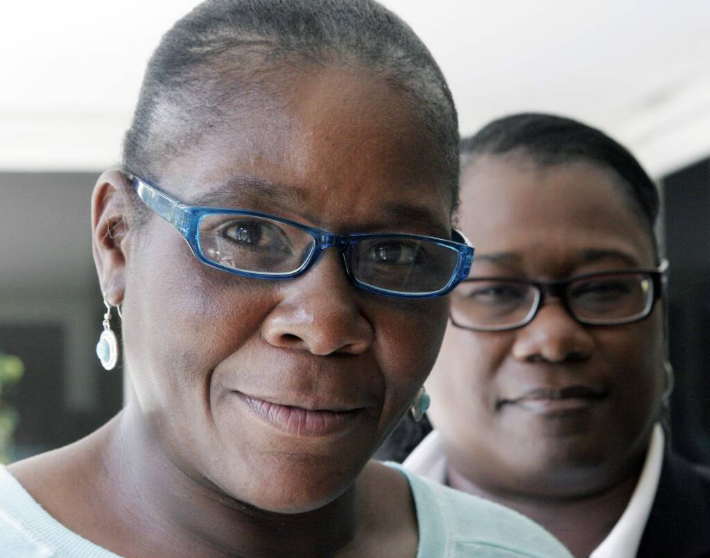 Marlene Pinnock, left, poses with her attorney, Caree Harper during an interview Sunday Aug. 10, 2014 in Los Angeles. Pinnock, a homeless woman, was beaten by a CHP officer in July 2014. Sunday was Pinnock's first publicized interview since the incident that was videotaped. (AP Photo/John Hopper)